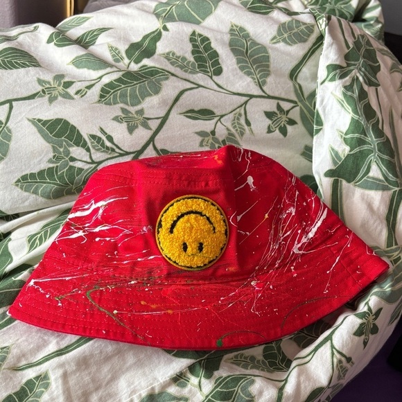 Upside down smiley, red bucket hat with paint